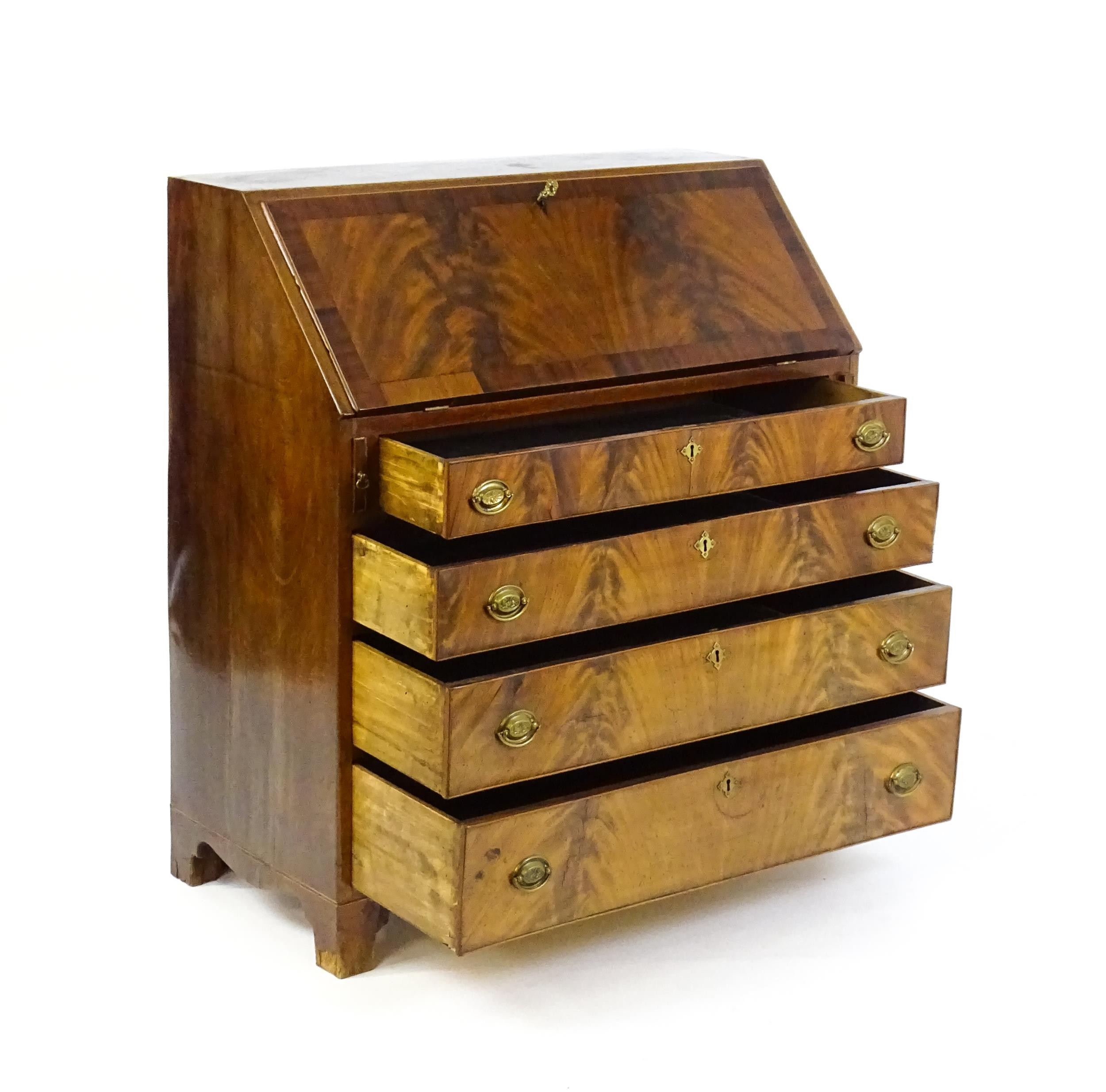 An early 19thC mahogany bureau with a fall front above four long graduated drawers with brass back - Image 2 of 6