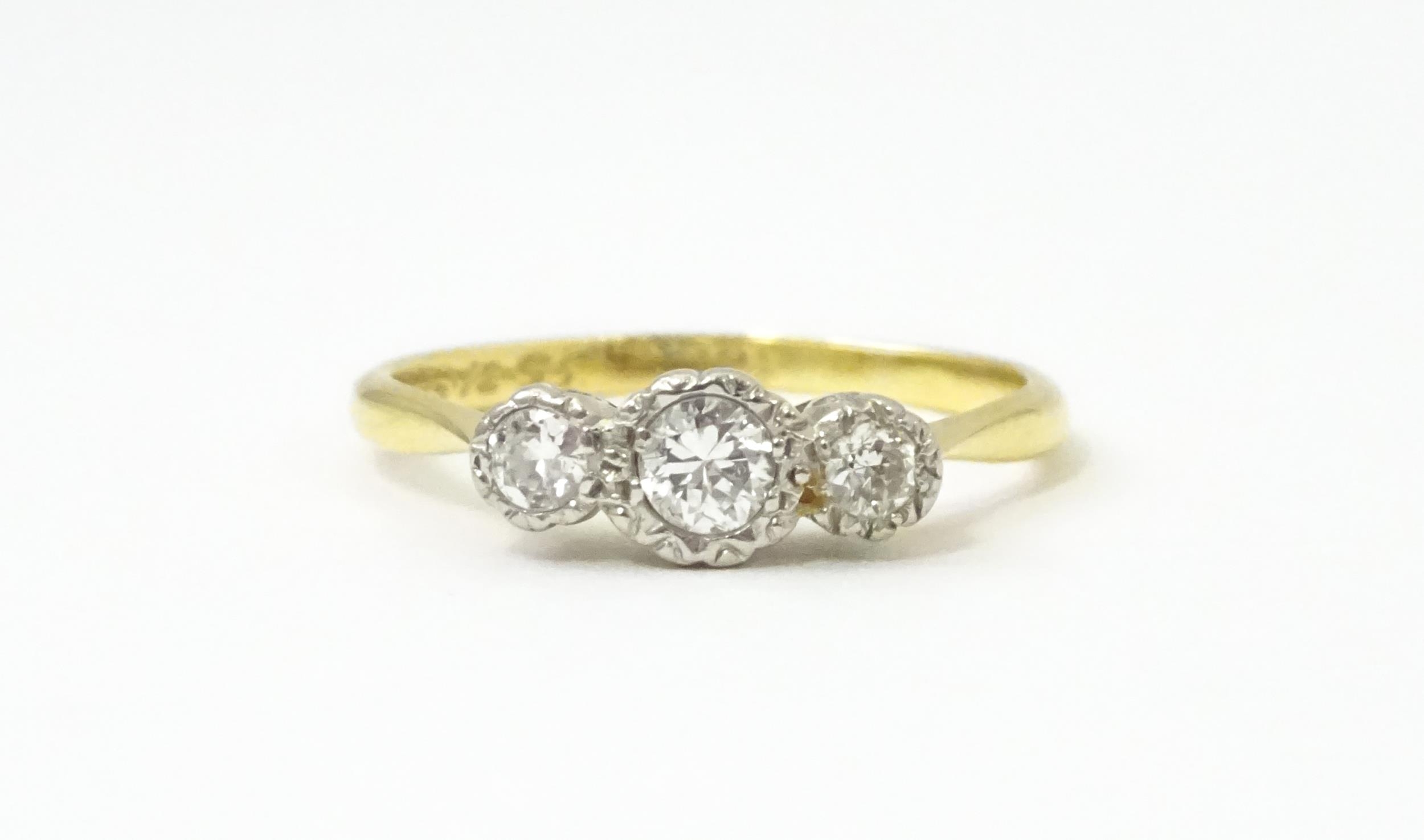 An 18ct gold ring with three platinum set diamonds. Ring size approx. O Please Note - we do not make - Image 7 of 18