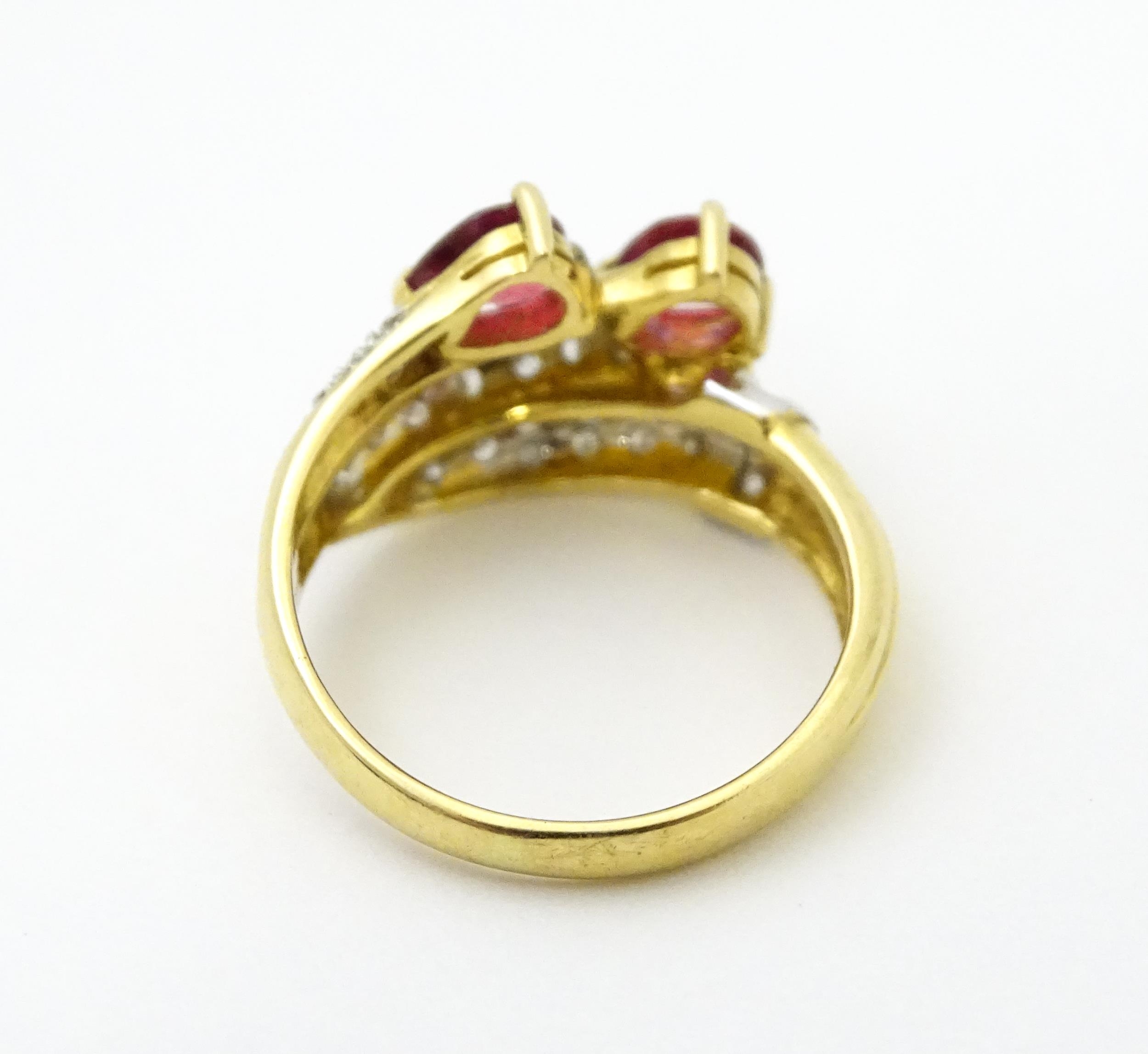 An 18ct gold ruby and diamond ring set with two rubies and a profusion of diamonds. Ring size - Image 5 of 6