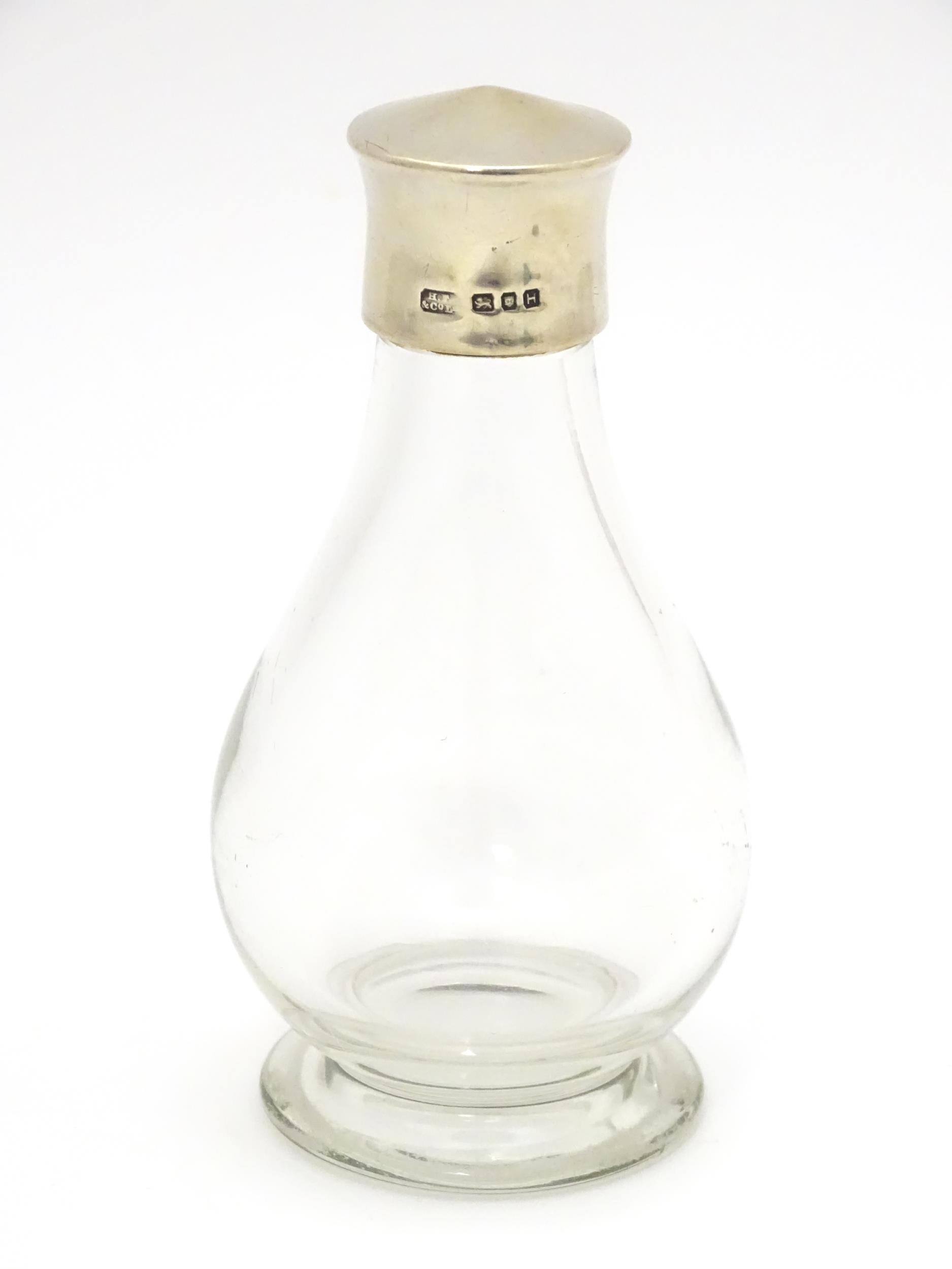 A glass private / travelling communion bottle / flask with silver screw lid, hallmarked London 1943,