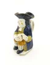 A 19thC Staffordshire pottery character Toby jug decorated in Pratt colours. Approx. 9 1/4" high