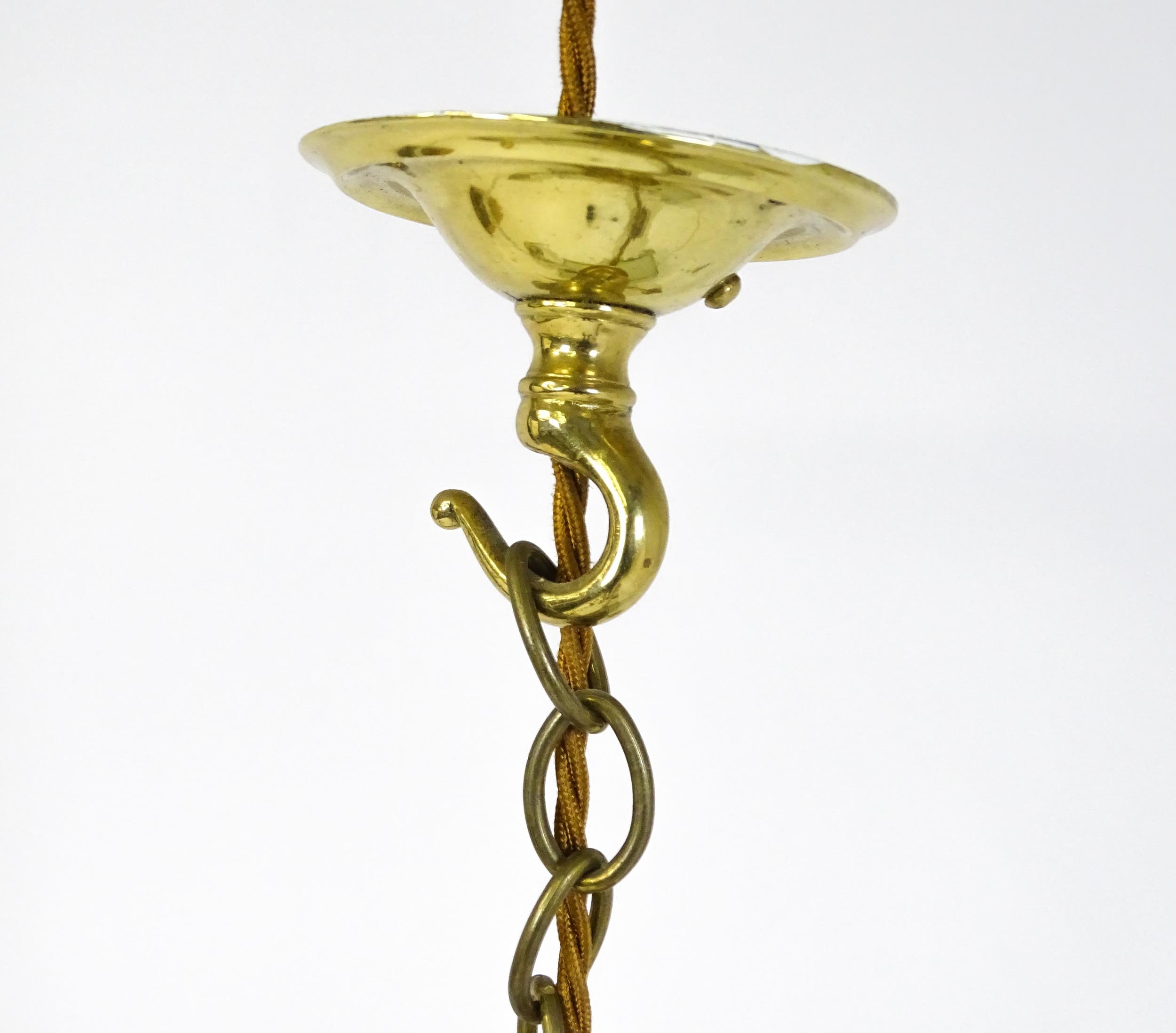A pair of brass pendant lights having three scrolling branches with three holophane shades. - Image 13 of 16