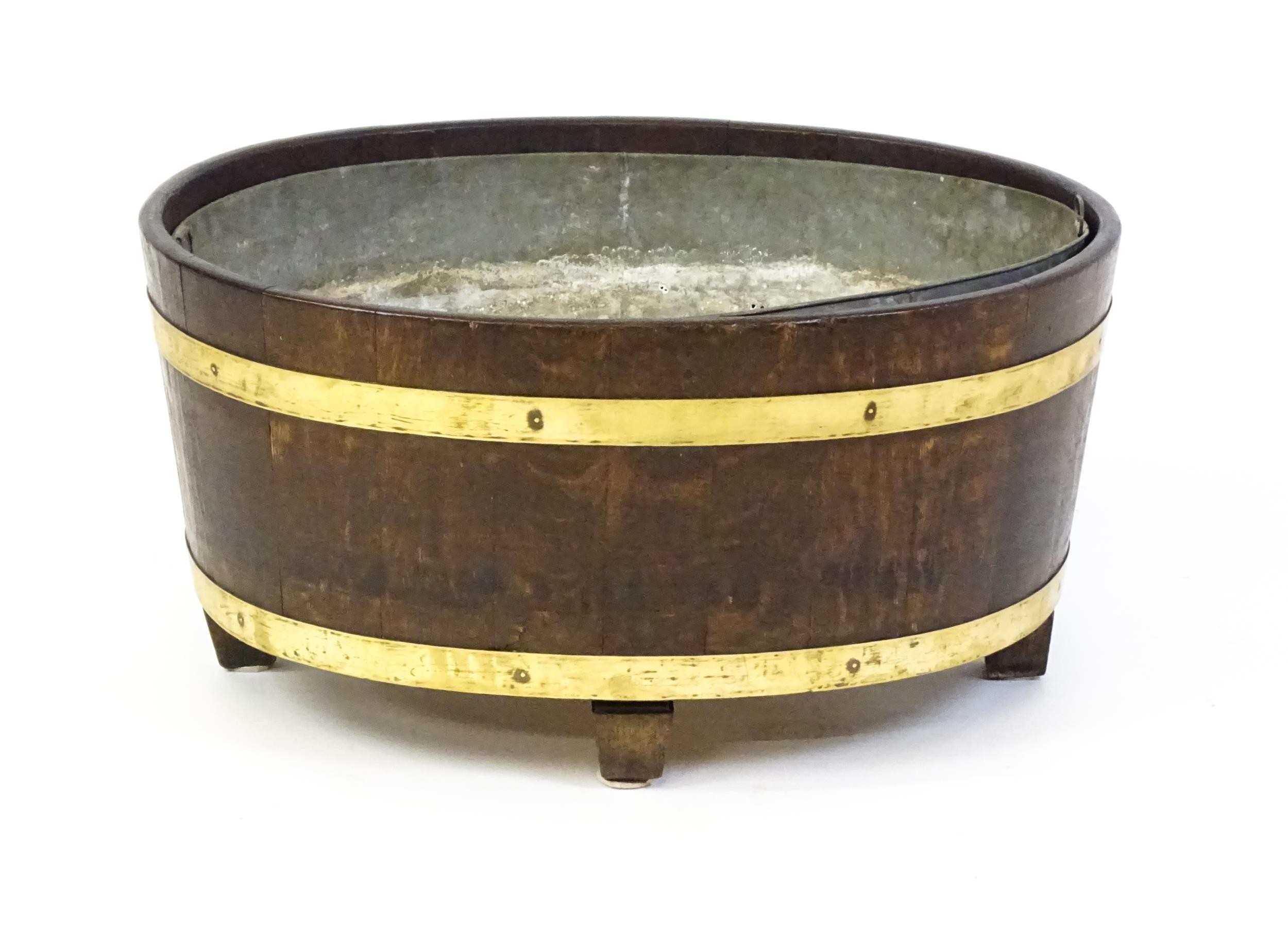 A late Georgian oak wine cooler / cellarette with a coopered and brass strapped frame and raised - Image 7 of 7