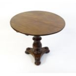 A late 19thC occasional table with a circular top above a turned pedestal and shaped base raised