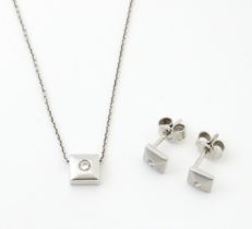 An 18ct white gold chain necklace with diamond set pendant together with matching stud earrings.