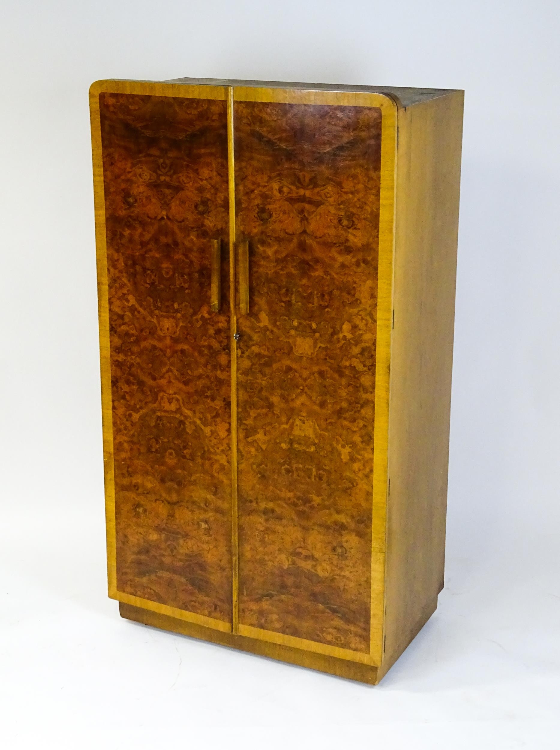 A mid 20thC Art Deco style wardrobe / cupboard with burr walnut veneered doors and shaped handles. - Image 6 of 7