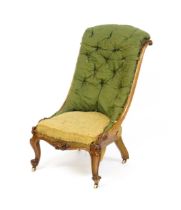 A Victorian mahogany nursing chair with a scrolled, deep buttoned backrest above carved cabriole