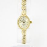A 9ct gold cased ladies wristwatch, the dial signed Sovereign, with 9ct gold bracelet watch strap.