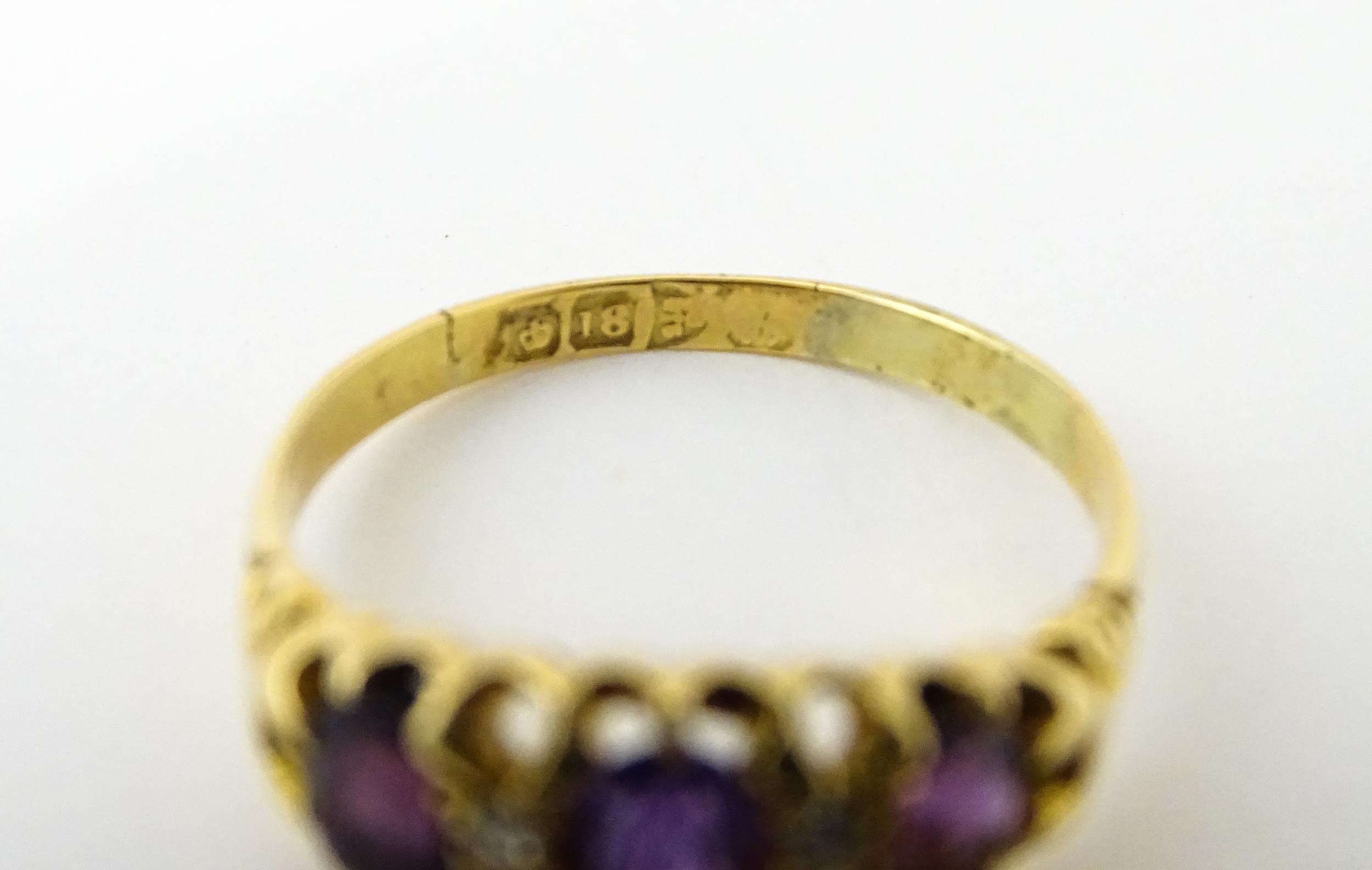 An 18ct gold ring set three graduated amethyst and four diamonds. Ring size approx. Q Please - Image 2 of 7