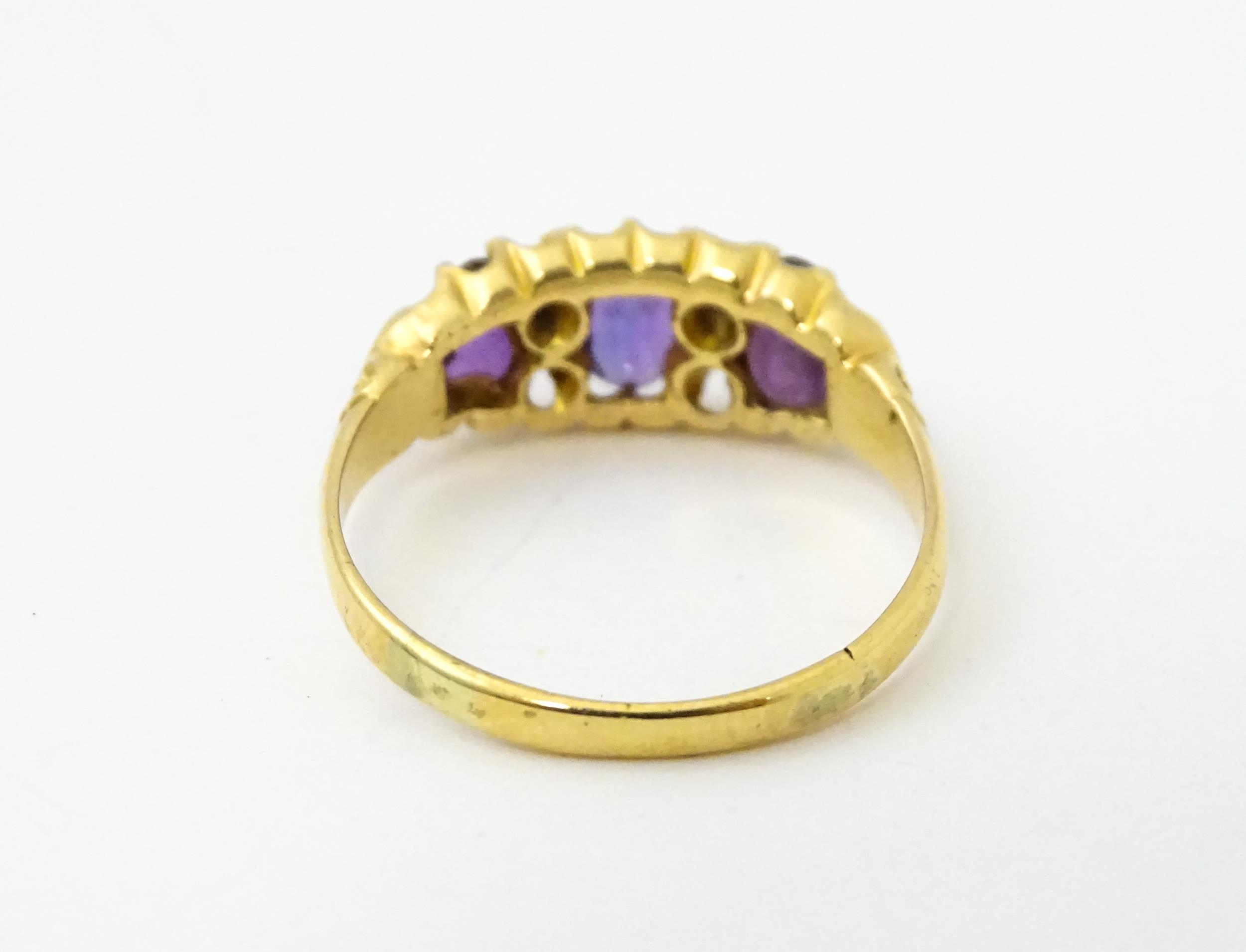 An 18ct gold ring set three graduated amethyst and four diamonds. Ring size approx. Q Please - Image 6 of 7