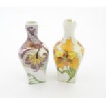 Two Rozenburg eggshell porcelain vases, one decorated with purple flowers, the other with orange