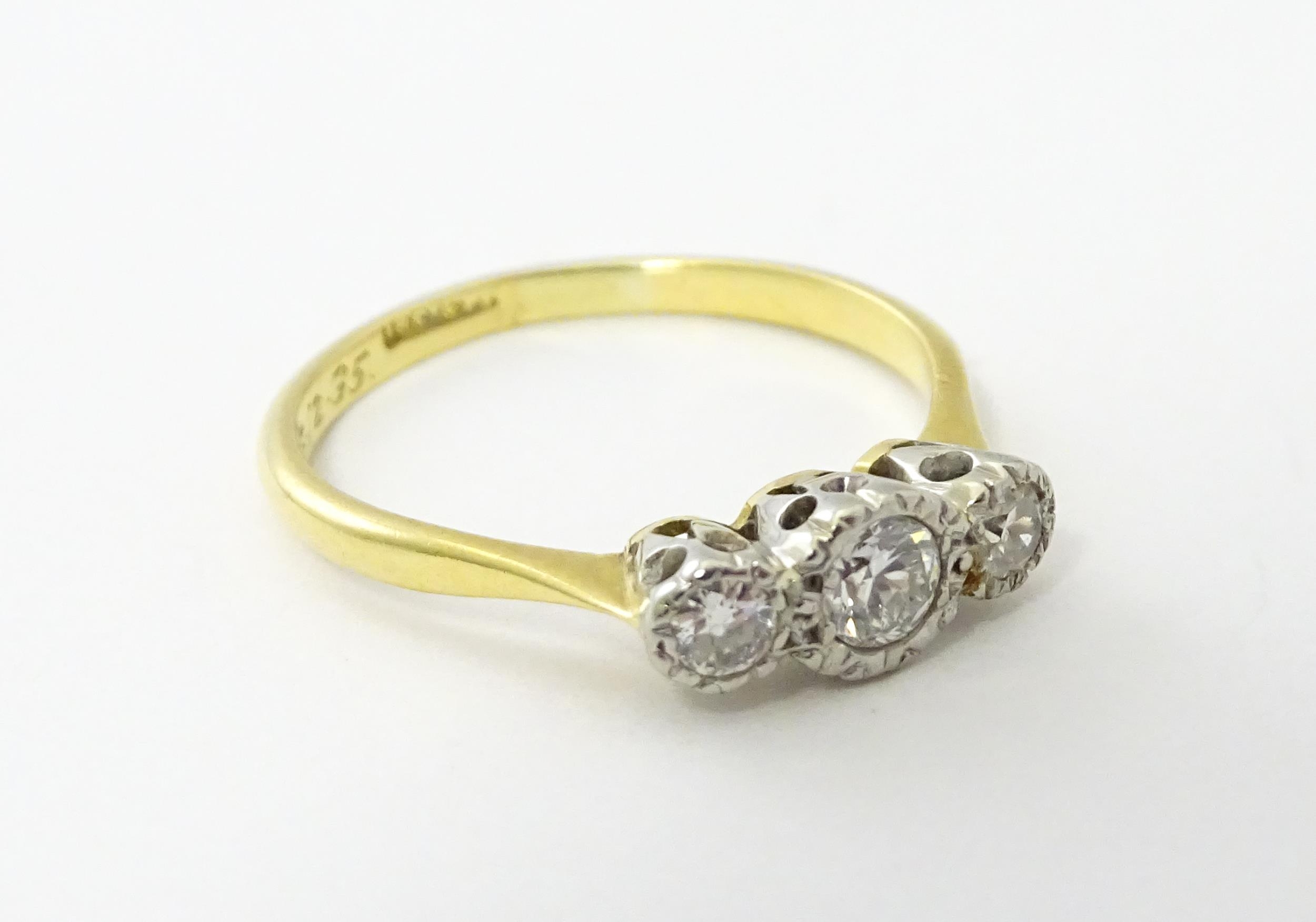 An 18ct gold ring with three platinum set diamonds. Ring size approx. O Please Note - we do not make - Image 8 of 18