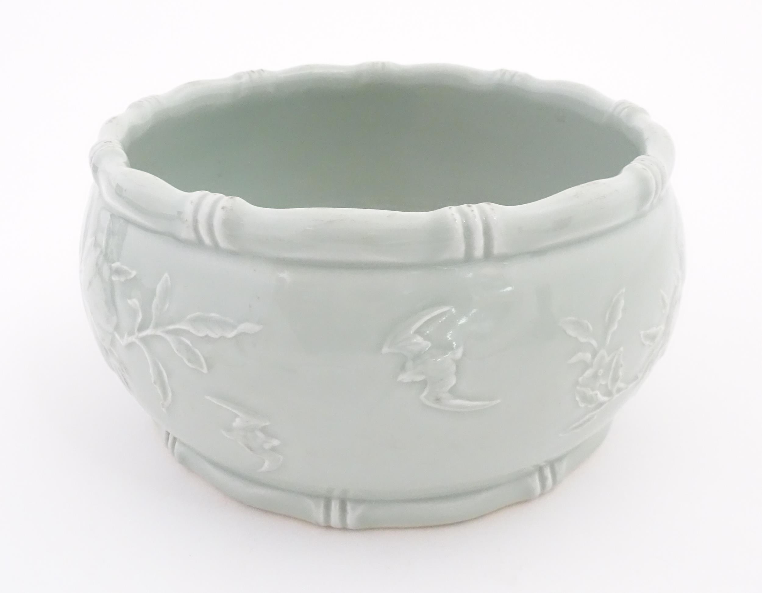 A Chinese celadon planter decorated in relief with peaches and bat detail, and stylised bamboo rims. - Image 5 of 7