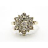 A 9ct gold ring set with diamonds in a floral cluster setting. Ring size approx. M Please Note -