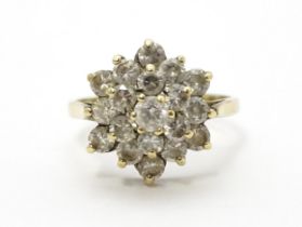 A 9ct gold ring set with diamonds in a floral cluster setting. Ring size approx. M Please Note -