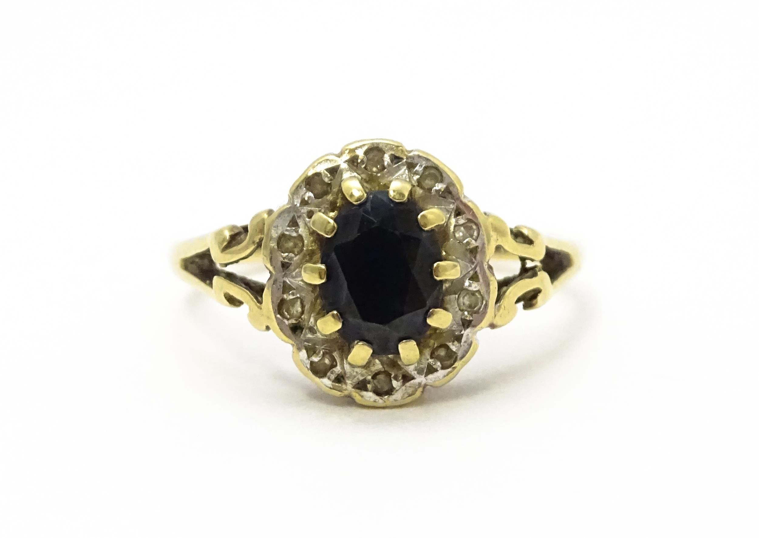 A 9ct gold ring set with central sapphire bordered by diamonds. Ring size approx. L 1/2 Please - Image 3 of 10