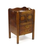 A George III mahogany tray top commode / bedside cabinet with two panelled doors above two short