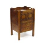 A George III mahogany tray top commode / bedside cabinet with two panelled doors above two short