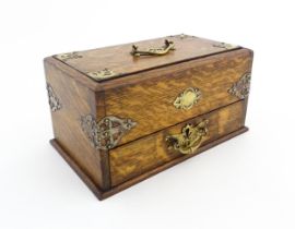 A Victorian oak humidor with brass mounts, the slide action top opening a when the drawer is drawn