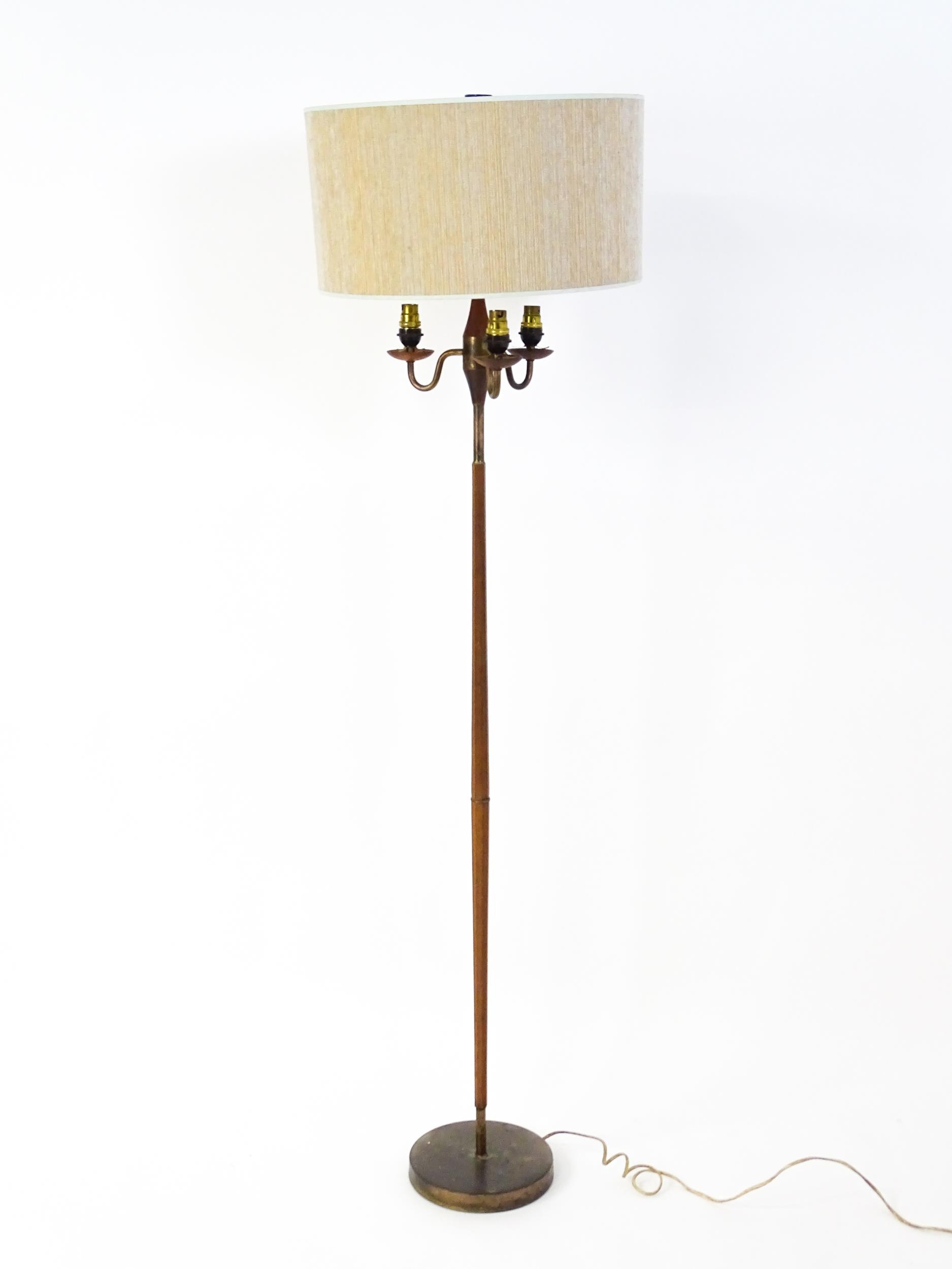 A 20thC three branch standard lamp. Approx. 62 1/2" high Please Note - we do not make reference to