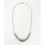 A silver necklace with silver gilt detail set with diamonds. Approx 18" long Please Note - we do not