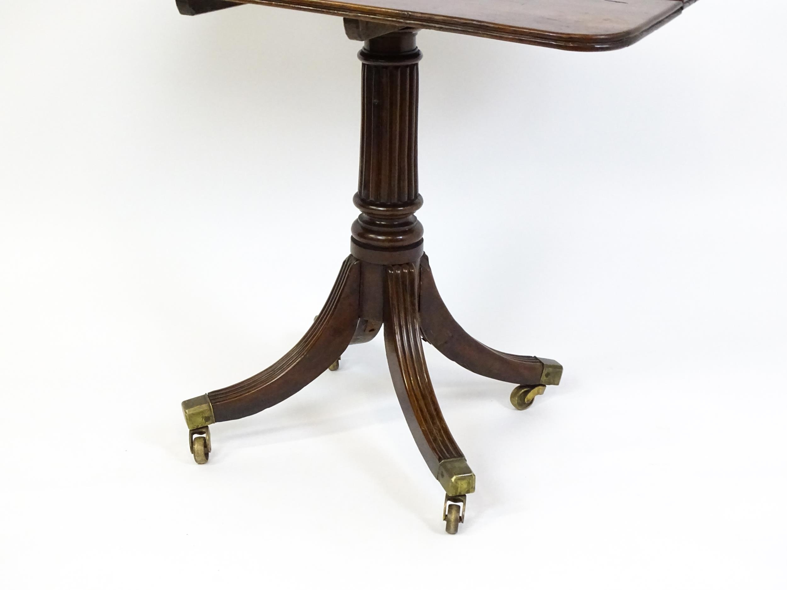 A 19thC tilt top occasional table with yew wood planked top above a reeded mahogany pedestal and - Image 13 of 13