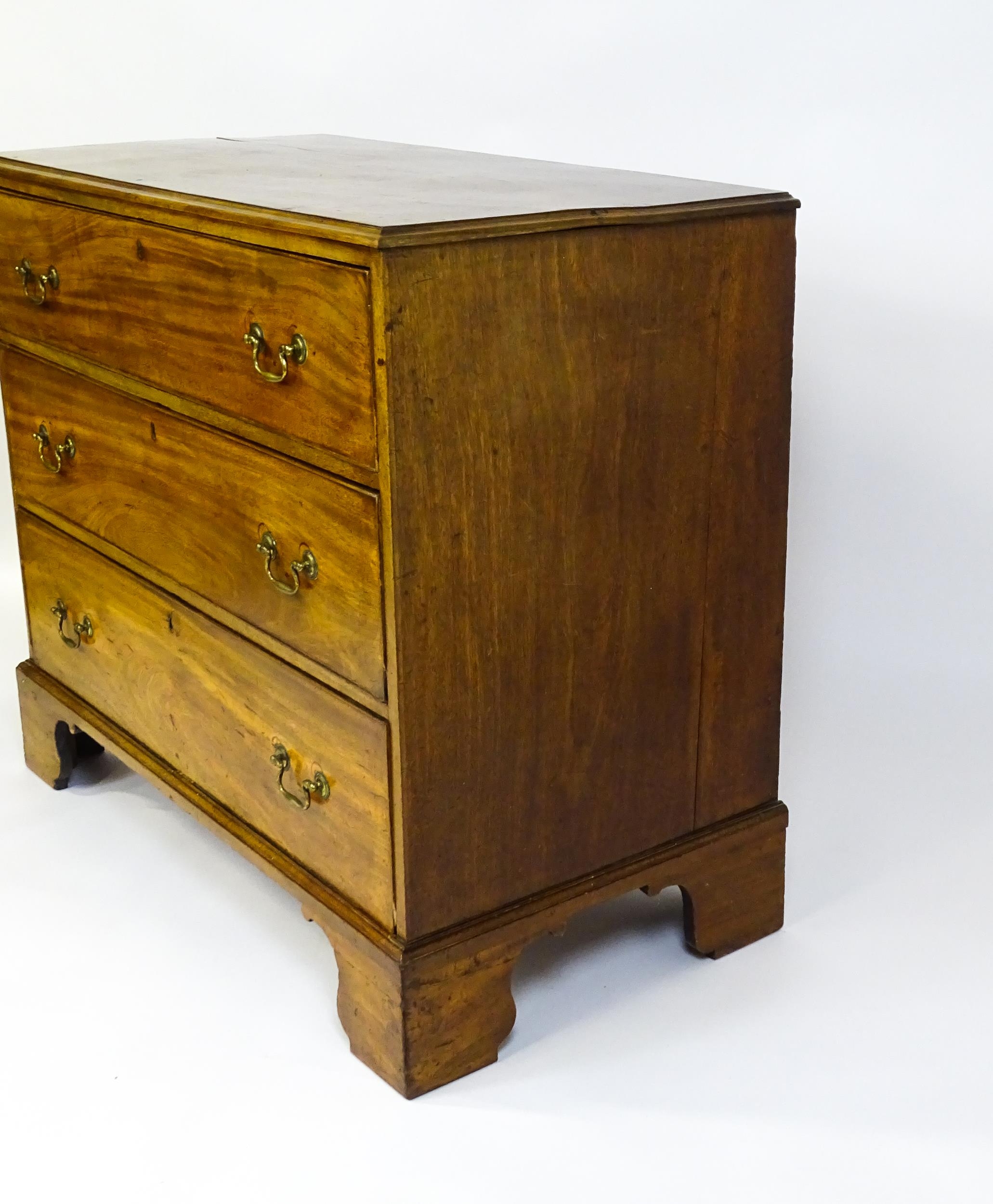 A late Georgian mahogany chest of drawers with a rectangular moulded top above three long drawers - Image 10 of 10