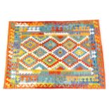 Carpet / Rug : A Turkish Anatolian kilim rug with repeating geometric motifs. Approx. 80" x 55"