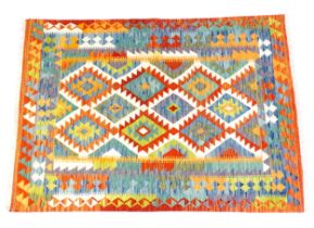 Carpet / Rug : A Turkish Anatolian kilim rug with repeating geometric motifs. Approx. 80" x 55"