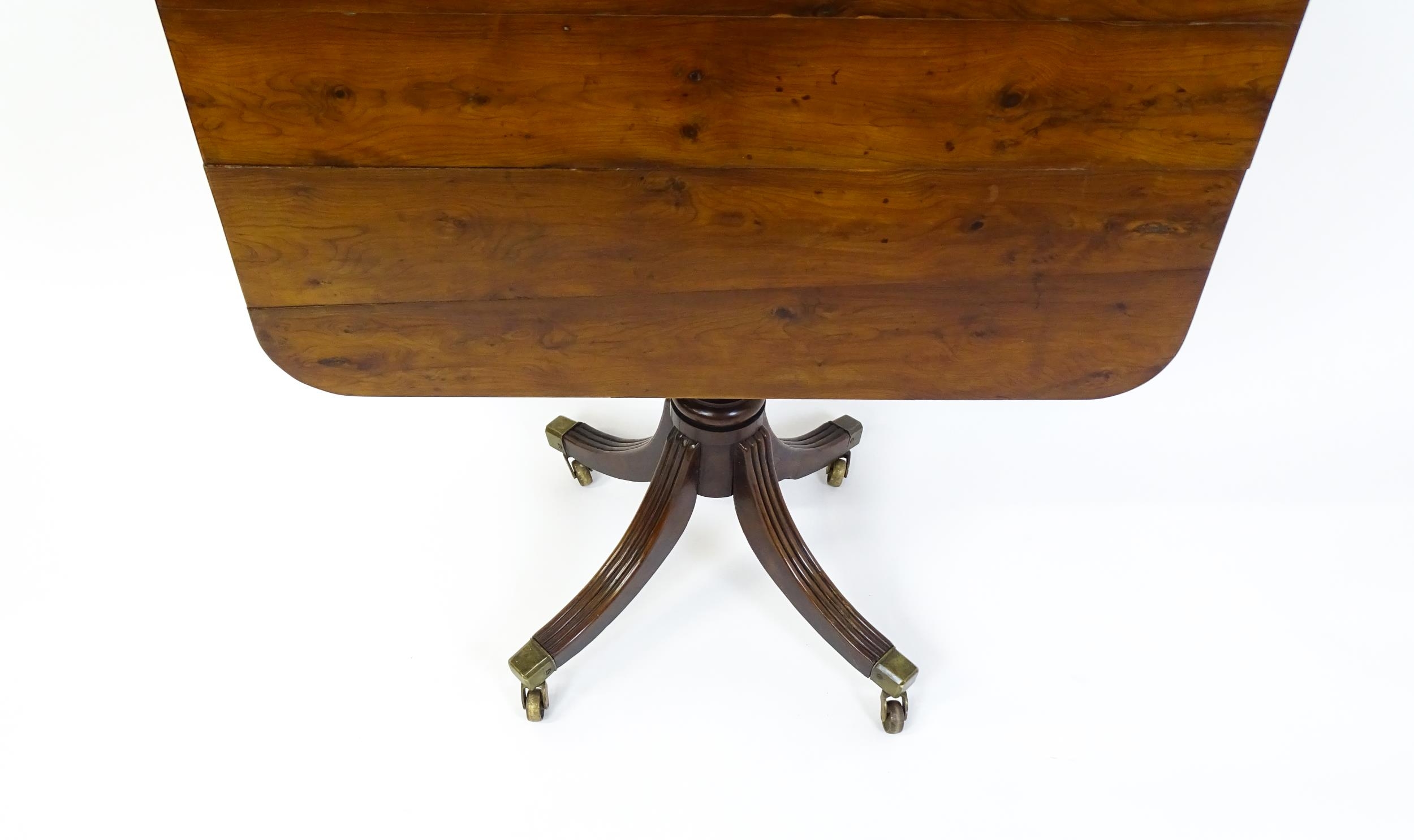 A 19thC tilt top occasional table with yew wood planked top above a reeded mahogany pedestal and - Image 7 of 13