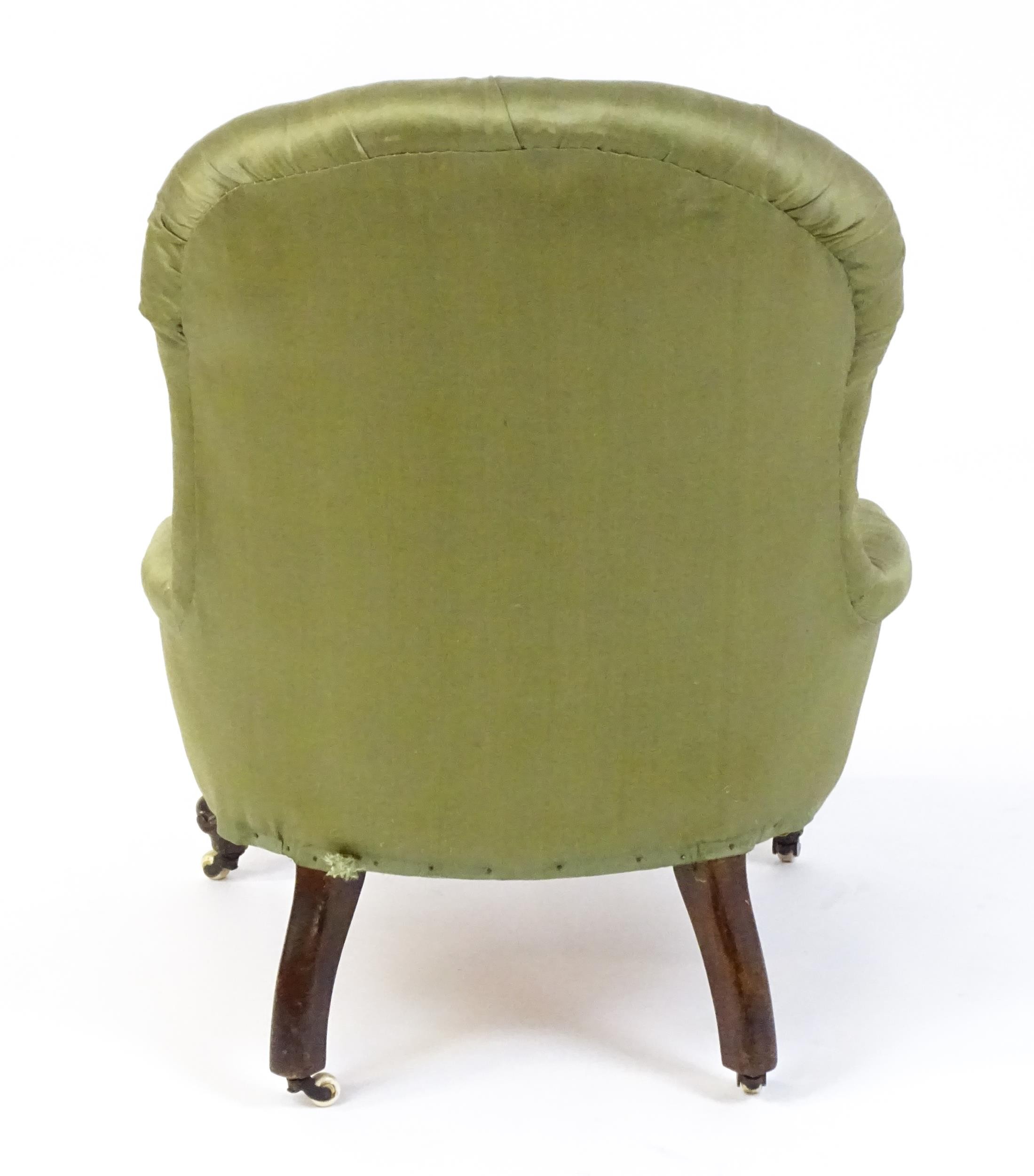 A late 19thC mahogany nursing chair with a deep buttoned backrest above a sprung seat and raised - Image 5 of 5