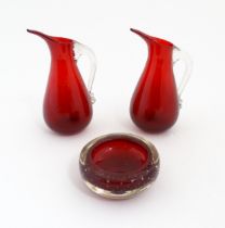 Two Whitefriars ruby glass jugs. Together with a studio glass bowl with controlled bubble detail .