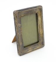 An easel back photograph frame with silver surround hallmarked Birmingham 1909 . Approx 4 1/2"