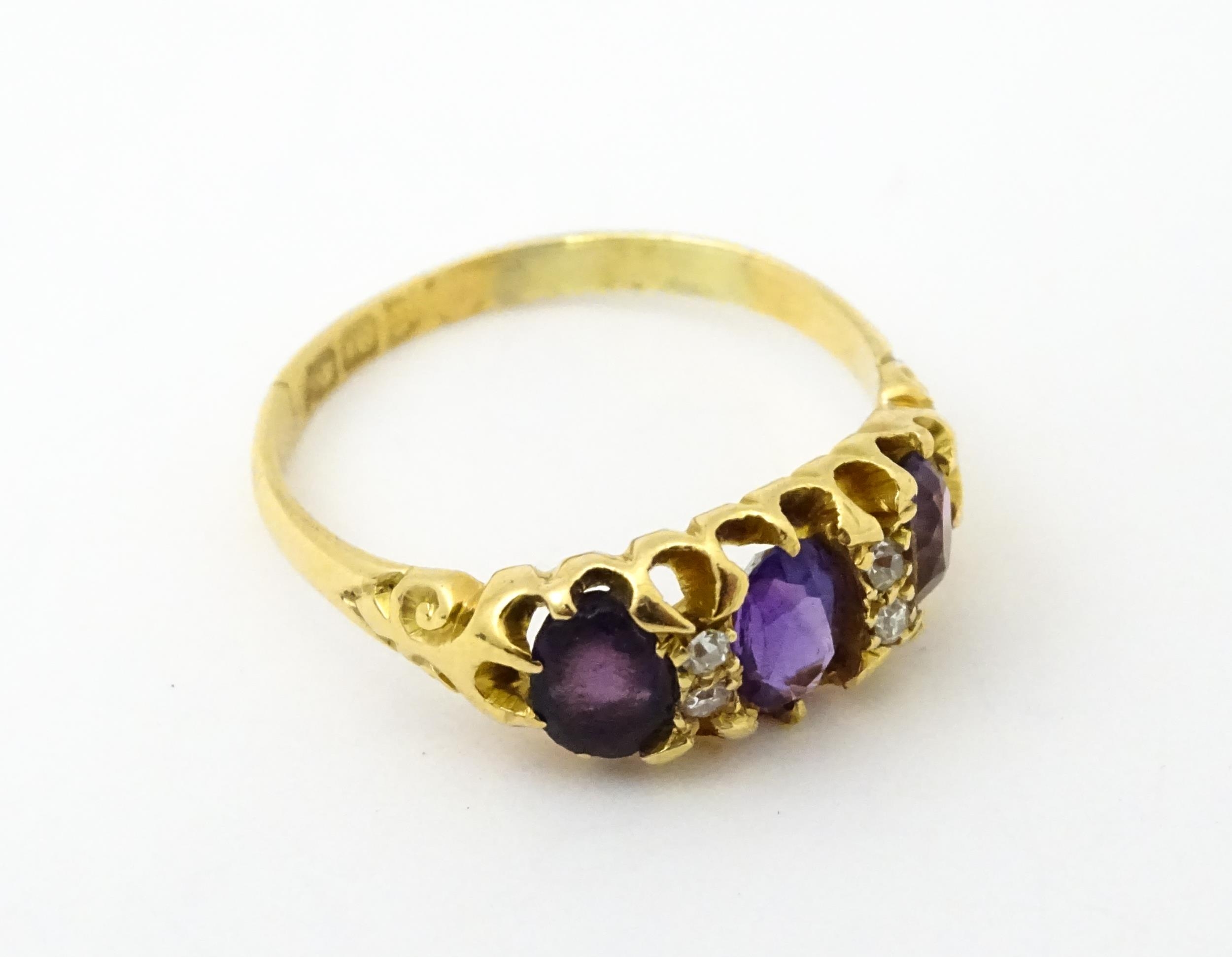 An 18ct gold ring set three graduated amethyst and four diamonds. Ring size approx. Q Please - Image 5 of 7
