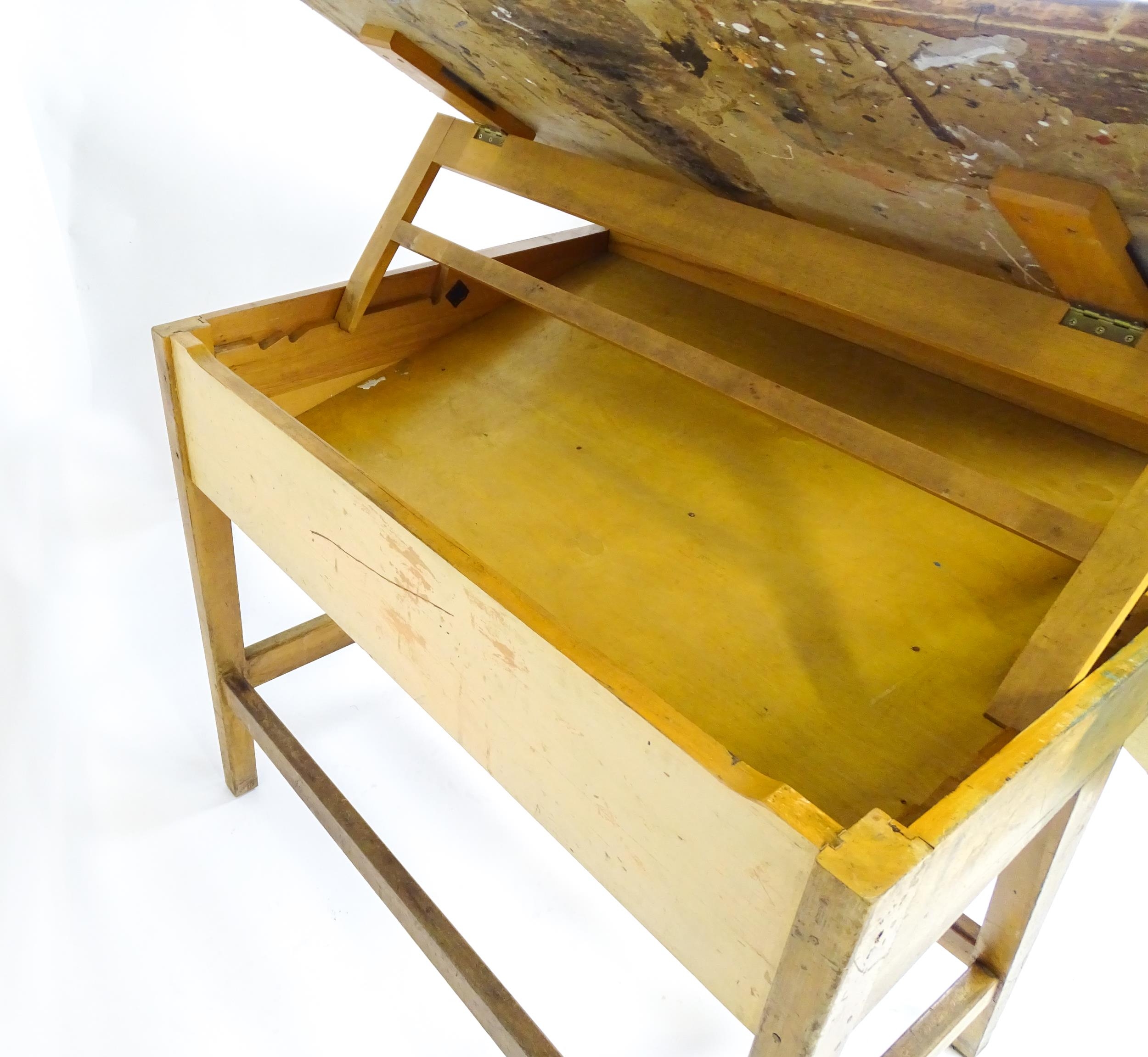 A mid / late 20thC artists desk with a hinged, adjustable top raised on tapering legs united by a - Image 9 of 11