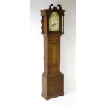 A 19thC oak cased 8-day longcase clock. The painted arch dial signed Foster Guildford. The case with