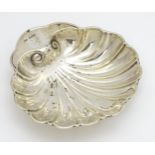 A silver butter dish of scallop shell form hallmarked Sheffield 1915, maker C. W. Fletcher & Son