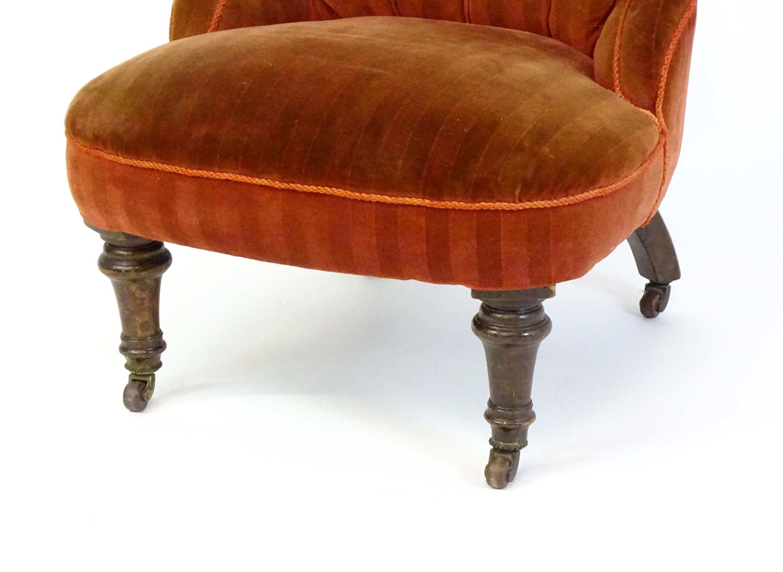 A late 19thC / early 20thC nursing chair with a deep buttoned backrest, sprung seat and raised on - Image 4 of 5