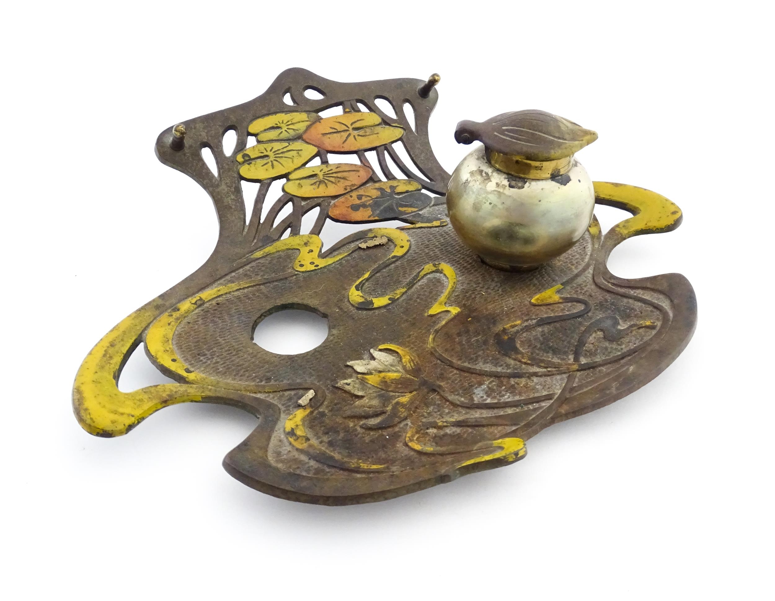 An Art Nouveau / Jugendstil cast standish of shaped form with enamel waterlily and lotus flower