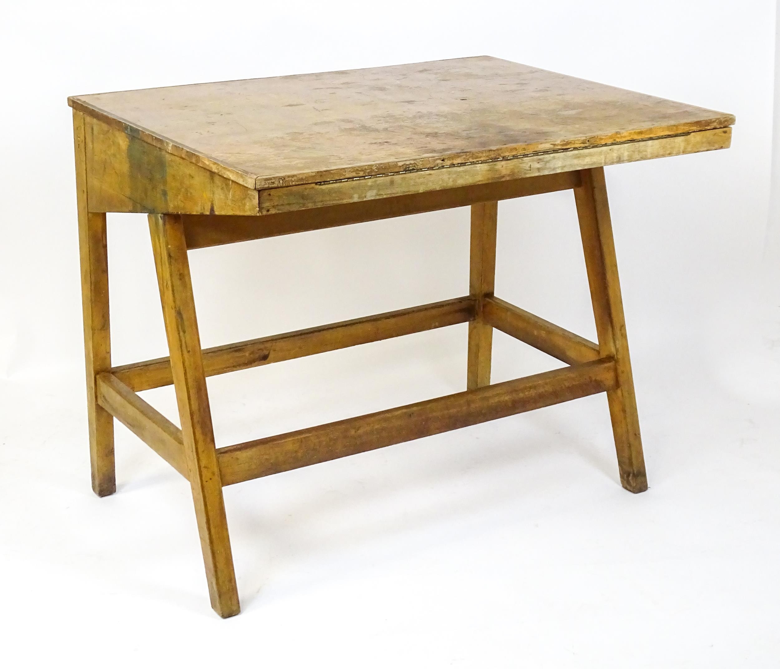 A mid / late 20thC artists desk with a hinged, adjustable top raised on tapering legs united by a - Image 3 of 11