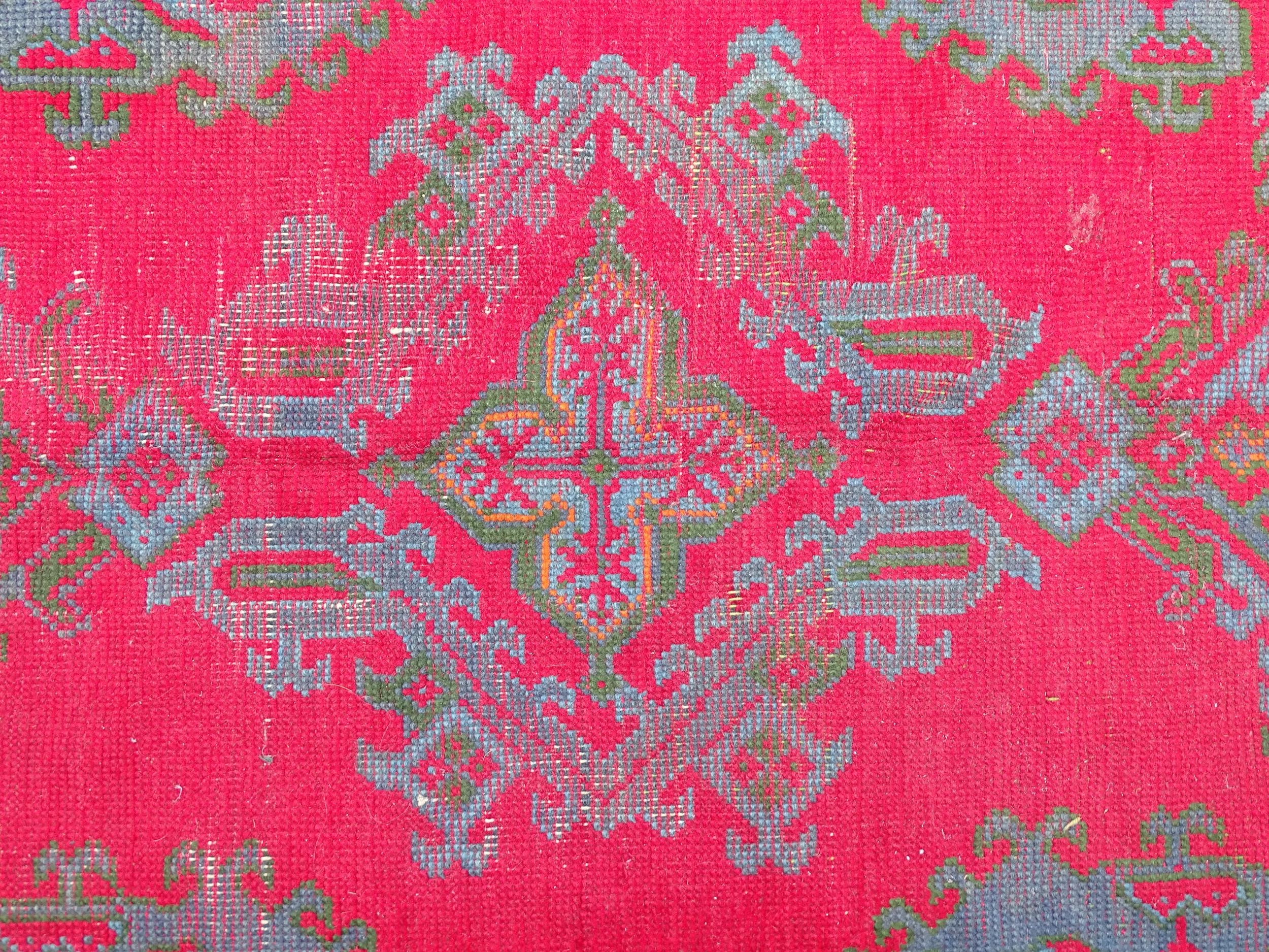 Carpet / Rug : A red ground rug decorated with floral, foliate and geometric detail worked in blue - Image 6 of 7