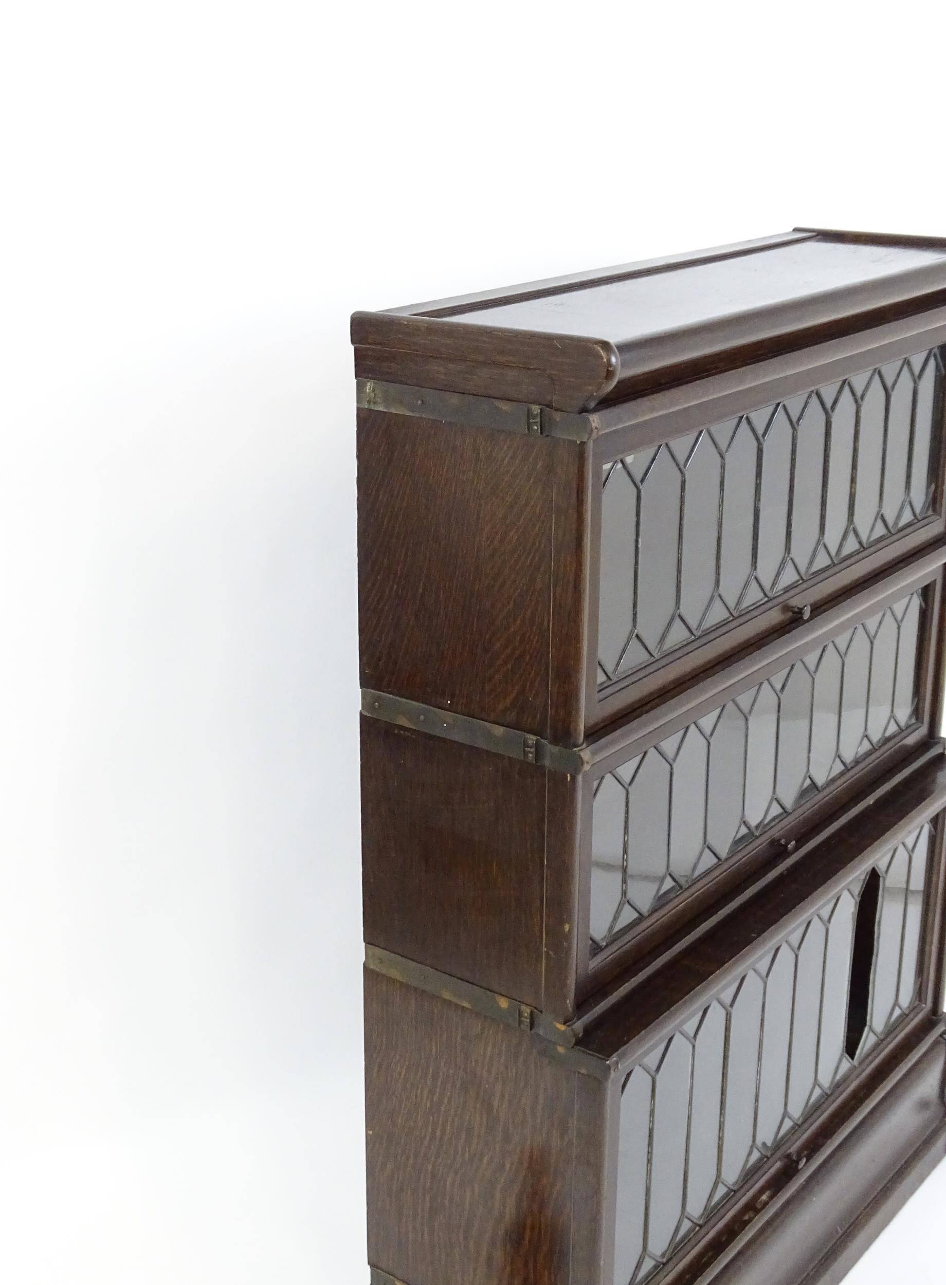 An early / mid 20thC oak Globe Wernicke bookcase with three glazed tiers above a shaped base. 34" - Image 3 of 8