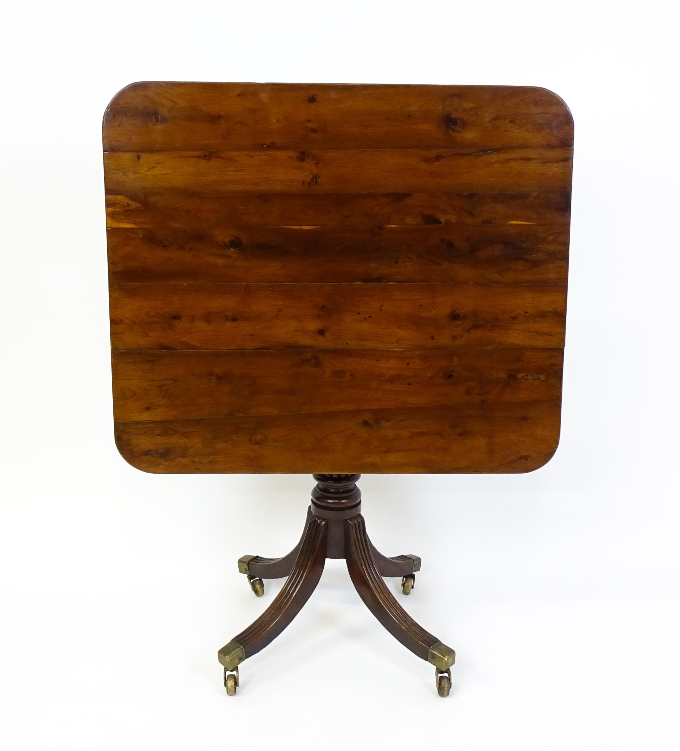 A 19thC tilt top occasional table with yew wood planked top above a reeded mahogany pedestal and - Image 8 of 13