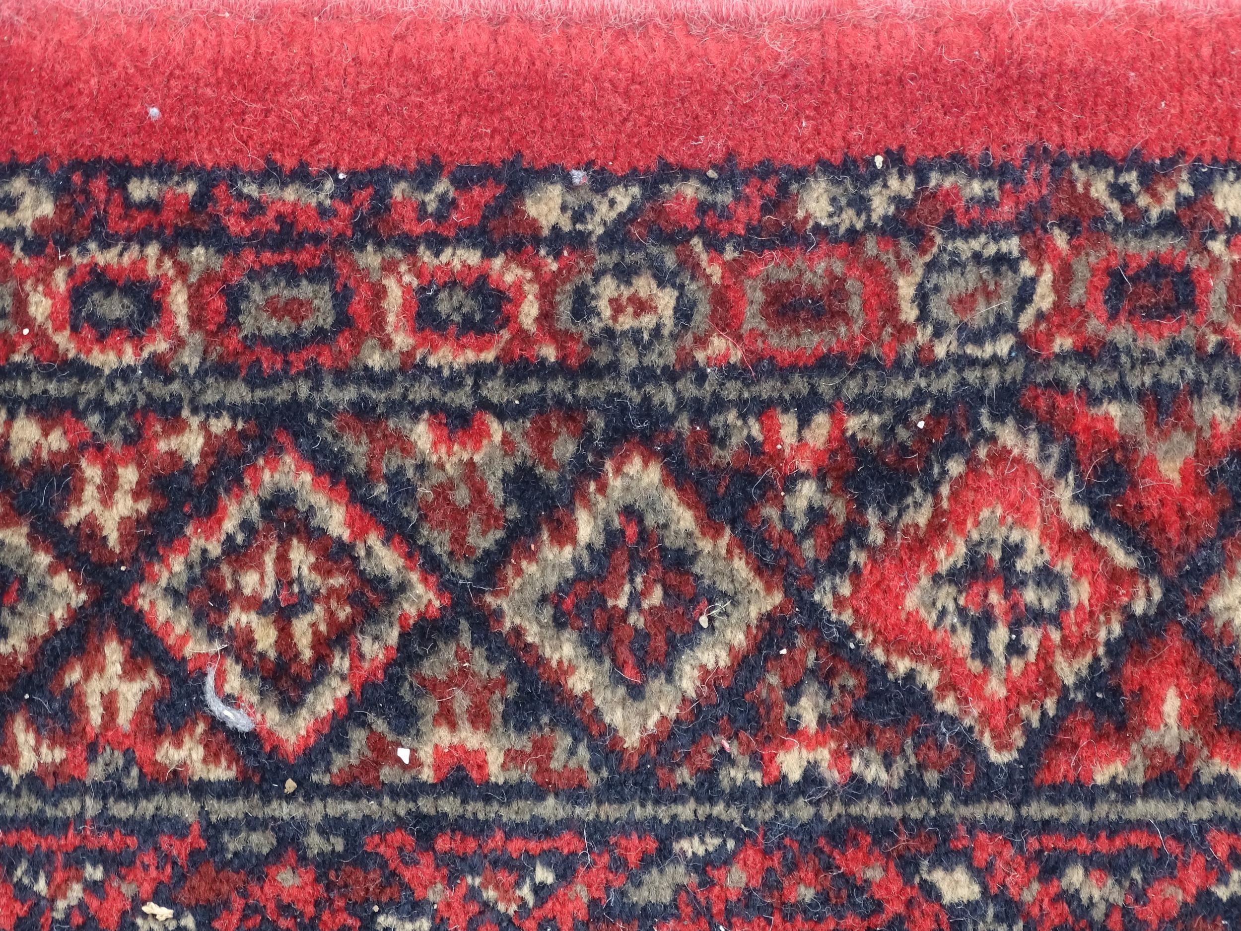 Carpet / Rug : A red ground runner with repeating motifs to centre, bordered by geometric banding. - Image 7 of 8