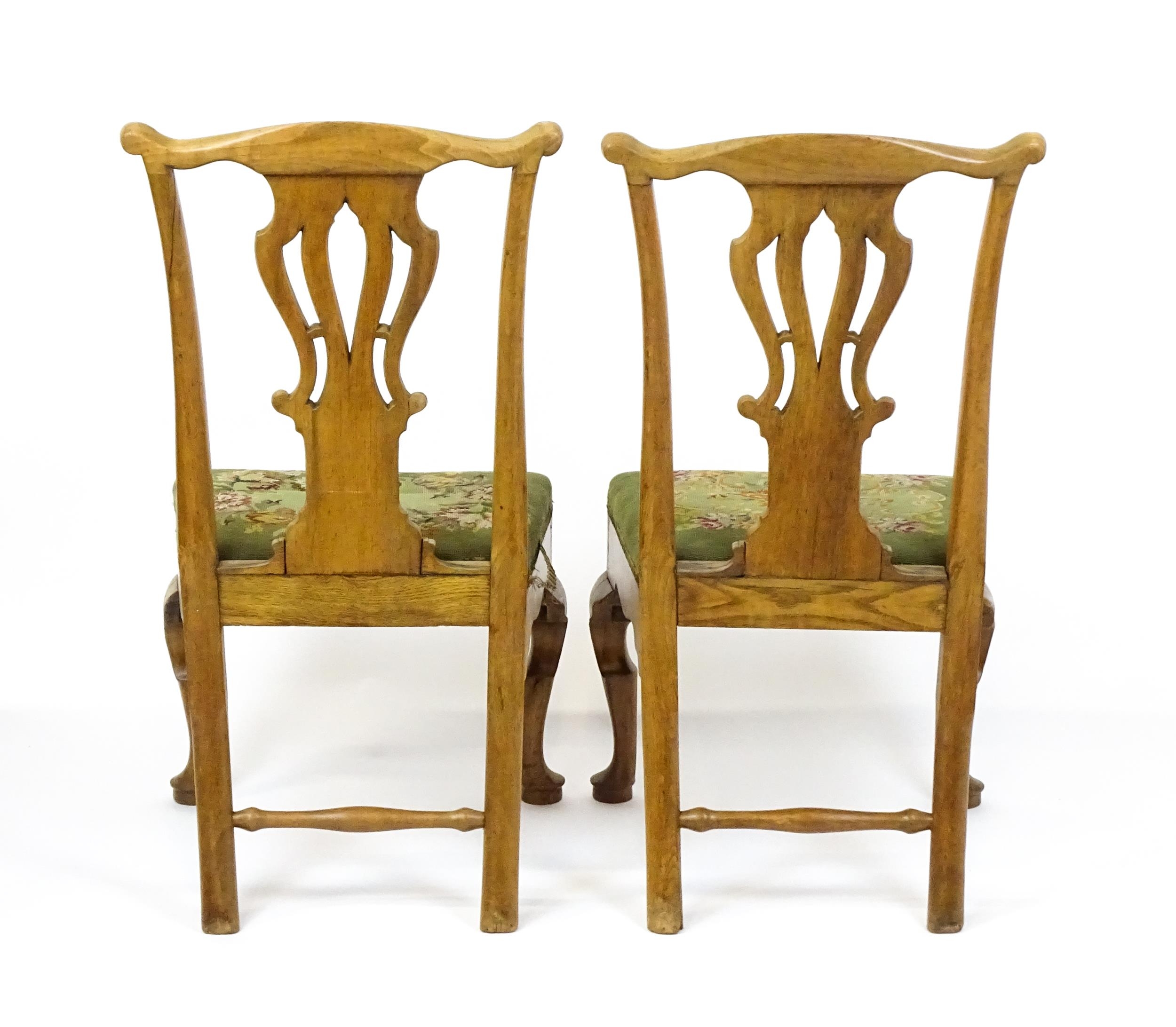 A pair of George II walnut side chairs with shaped top rails above pierced splats and raised on - Image 2 of 7