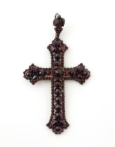 A Victorian pendant of crucifix form set with garnets. Approx 3" long Please Note - we do not make