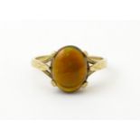 A 9ct gold ring set with fire opal cabochon. Ring size approx. R. Please Note - we do not make