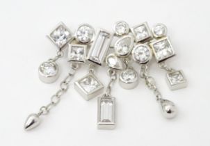 A silver brooch set with cubic zirconia. Approx. 1 1/2" wide Please Note - we do not make