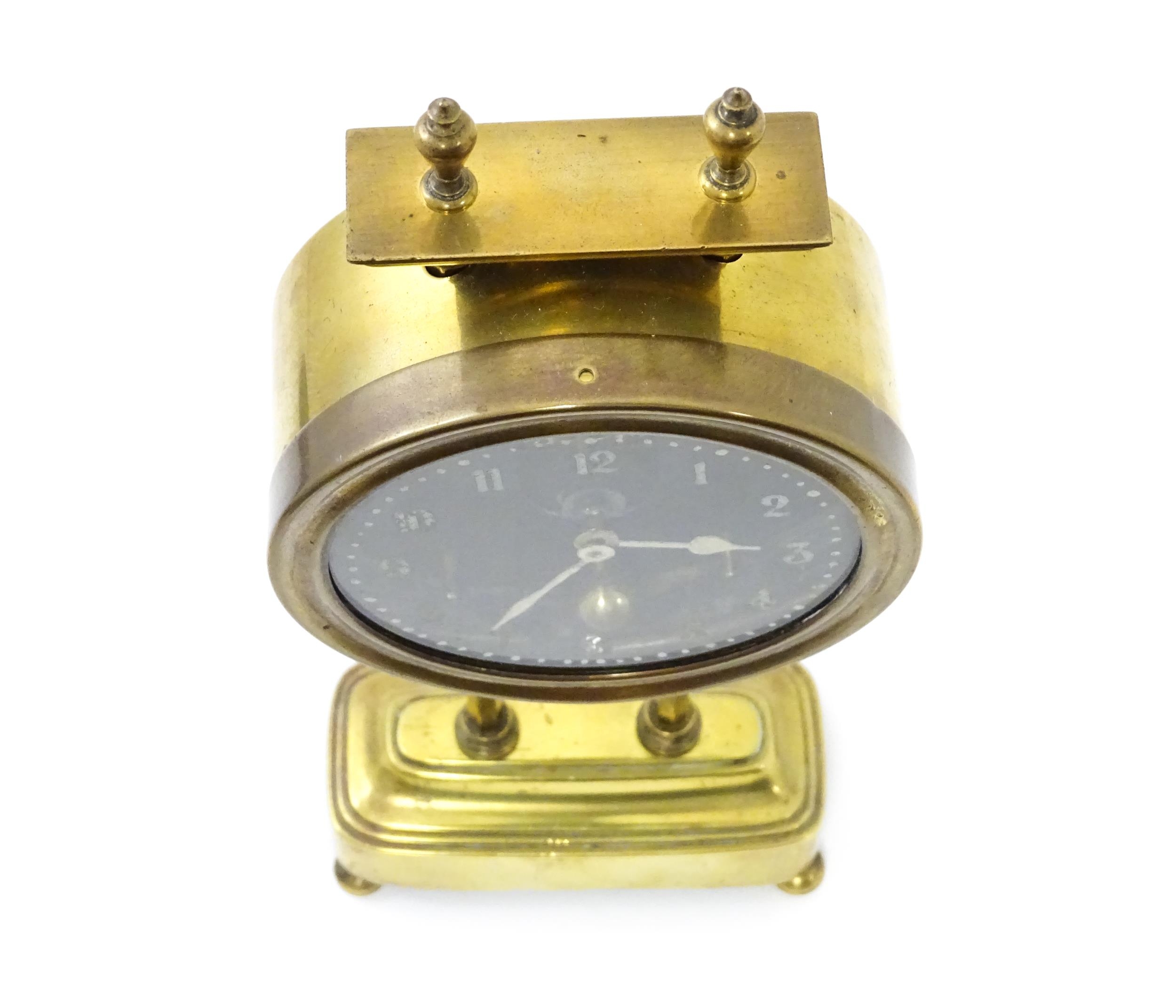 A brass cased Gravity clock with dial with Arabic numerals and having exposed escapement. Marked - Image 9 of 9