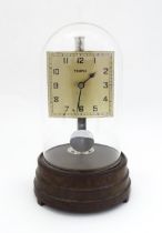 A Tempex electric clock mounted on a Bakelite base with chrome fitting. The squared dial with Arabic